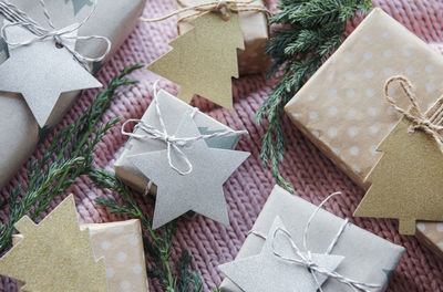 Christmas presents on pink knitted textile background. 