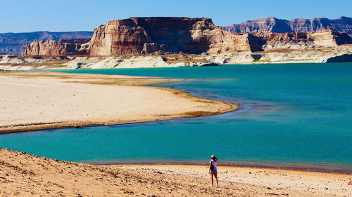 Rear view of man standing by lake powell 