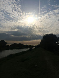 Scenic view of field against sky during sunset