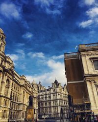 Low angle view of building against cloudy sky