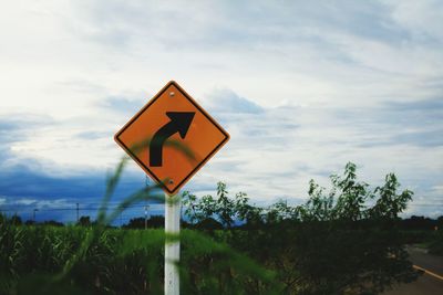 Road sign against sky