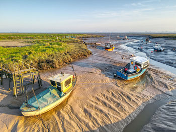 High angle view of boats moored on beach against sky