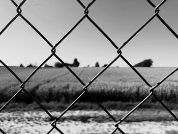 Close-up of chainlink fence against sky