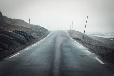 Road amidst mountains against sky