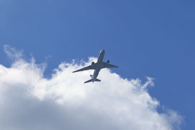 Low angle view of airplane flying in sky