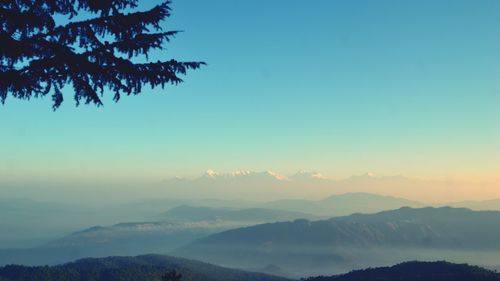 Scenic view of silhouette mountains against sky at sunset