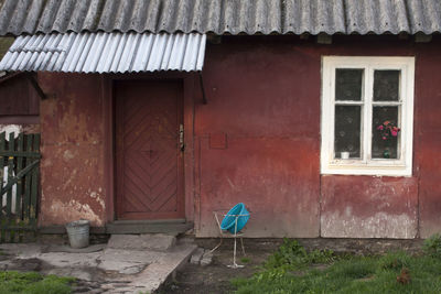 Rear view of woman standing against building