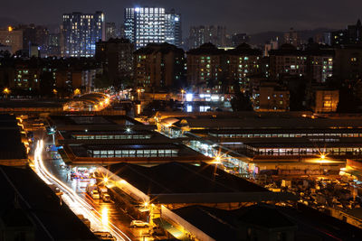High angle view of illuminated buildings in city at night