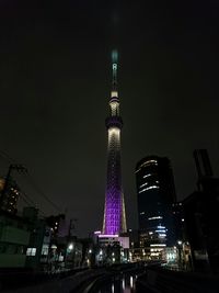 Low angle view of illuminated tower at night