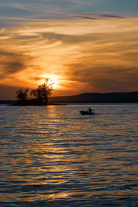 Scenic view of sea against orange sky