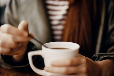 Midsection of woman using mobile phone