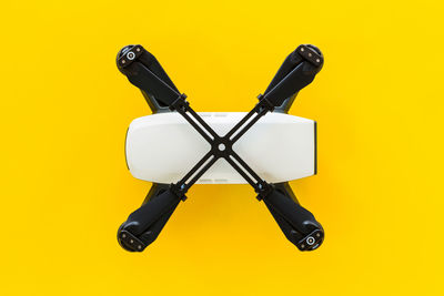 High angle view of electric lamp against yellow background