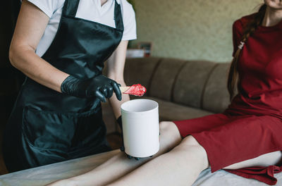 Midsection of couple holding coffee