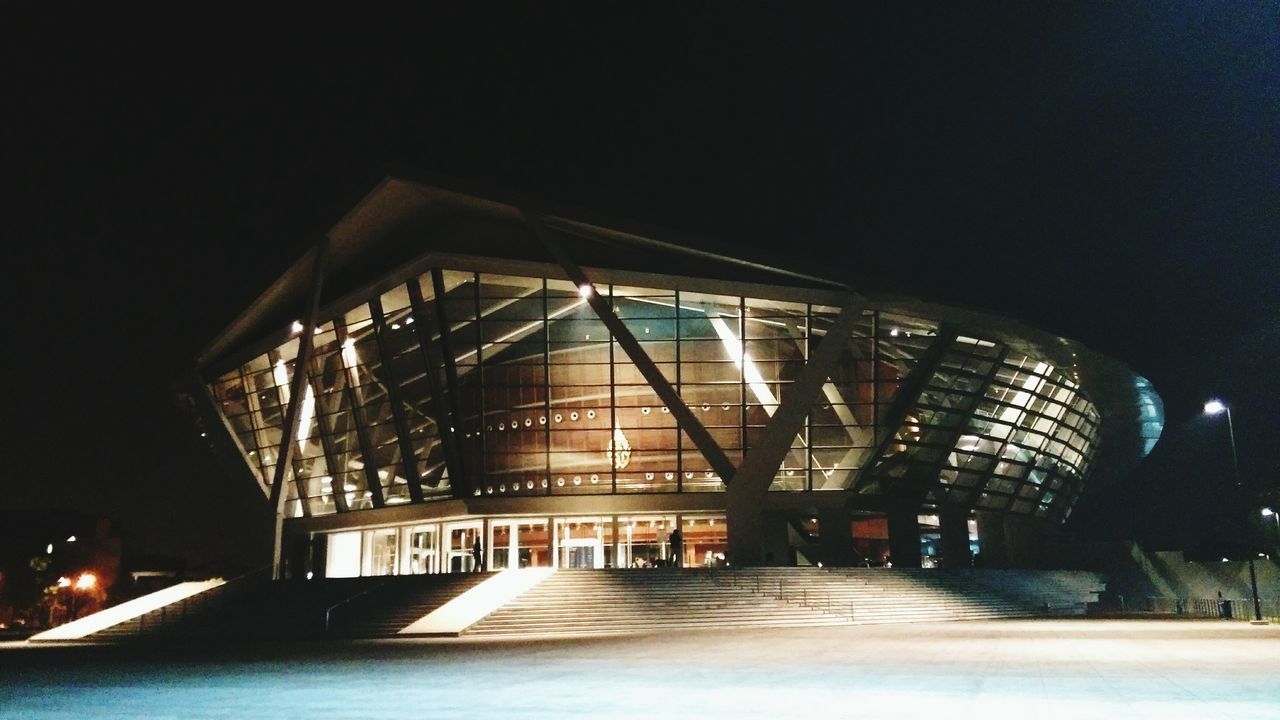 architecture, built structure, illuminated, night, indoors, building exterior, modern, city, low angle view, building, railing, sky, reflection, no people, dark, the way forward, bridge - man made structure, lighting equipment, connection, light - natural phenomenon