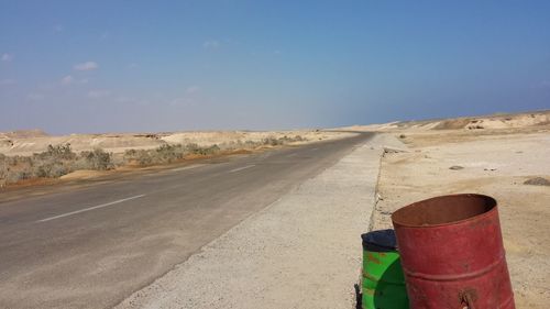 Road by landscape against sky