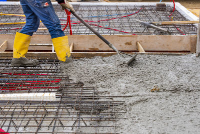 Low section of man working at construction site