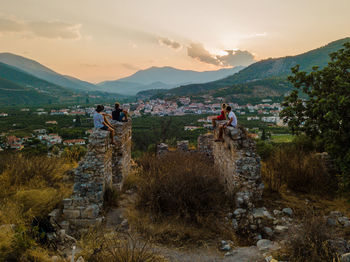 People on mountain against sky