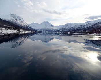 Scenic view of lake and mountains against sky