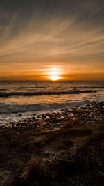 Scenic view of sea against sky at sunset