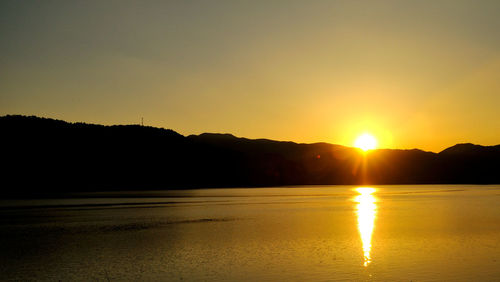 Scenic view of calm sea at sunset