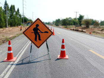 Arrow sign on road in city