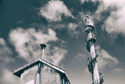 Low angle view of building against cloudy sky