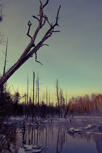 Frozen lake against sky during winter
