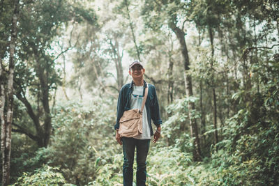 Full length of young man walking in forest