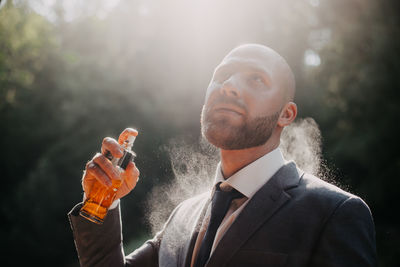 Young man blowing bubbles