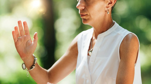 Woman practicing qi gong in a forest