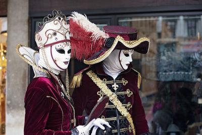 People wearing masks and traditional clothing