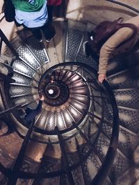 Low section of people standing on spiral staircase