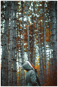 Man standing by trees in forest during autumn