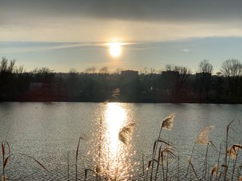 Scenic view of lake against sky during sunset