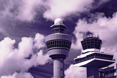 Low angle view of air traffic control tower against cloudy sky