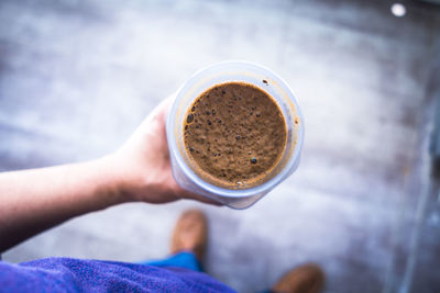 Low section of man holding coffee