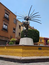 Low angle view of statue against building