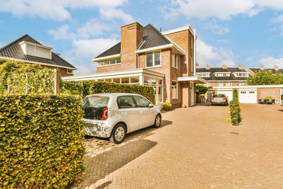 Cars on street against sky