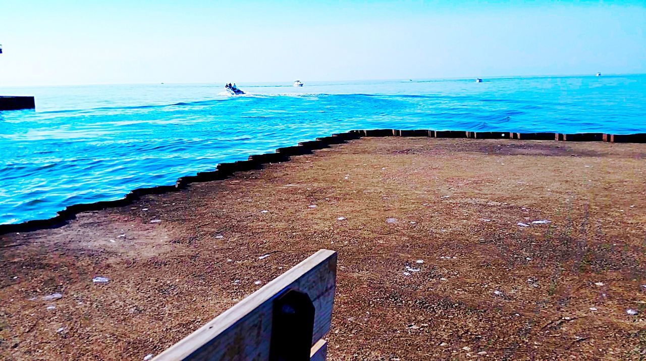 sea, horizon over water, water, blue, clear sky, beach, tranquil scene, tranquility, scenics, nature, shore, beauty in nature, copy space, transportation, sky, idyllic, day, sand, railing, nautical vessel