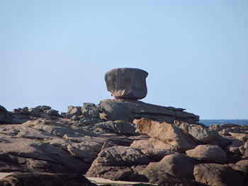 Rock formations against clear sky on sunny day