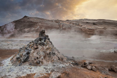 View of steaming fumarole in geothermal area of hverir at namafjall at sunset