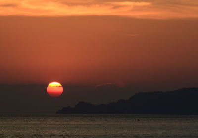 Scenic view of sea against romantic sky at sunset