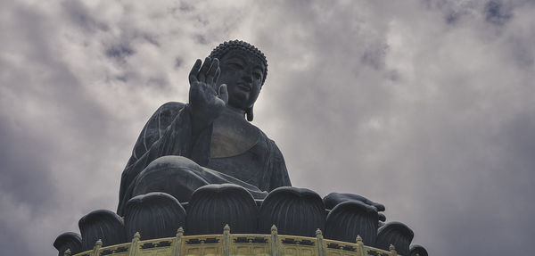 Low angle view of statue against cloudy sky