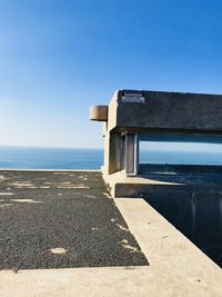 Built structure on beach against clear blue sky