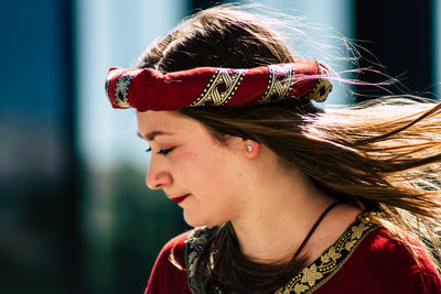 Close-up portrait of young woman looking away