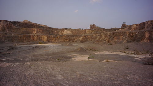 Scenic view of arid landscape against sky