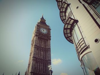 Low angle view of clock tower against sky