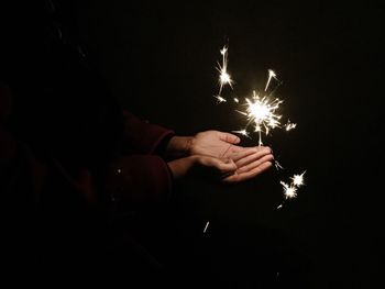 Man holding lit candles