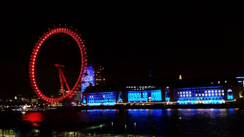 Illuminated ferris wheel at night