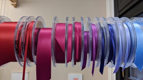 Close-up of multi colored clothes hanging in row